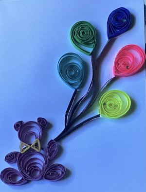 Photo of a quilling project of a bear with balloons