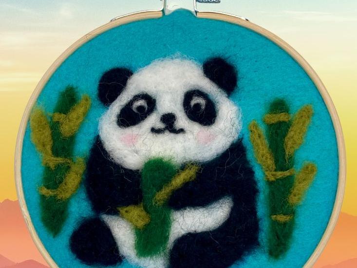 Image of a panda bear made with felt stretched on a needlepoint hoop
