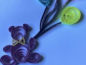 Photo of a quilling project of a bear with balloons