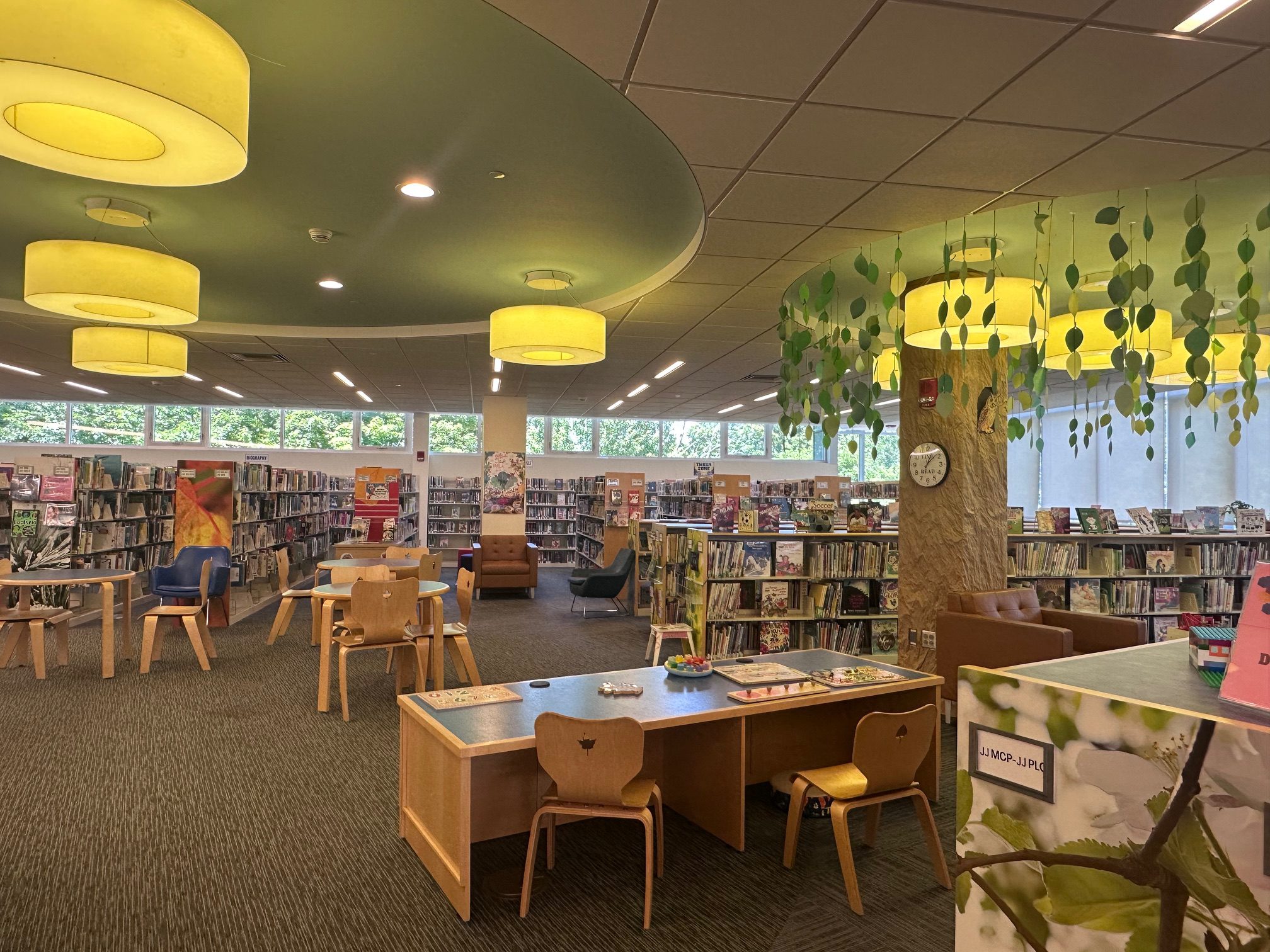 Interior of the library with book shelves and warm lamps